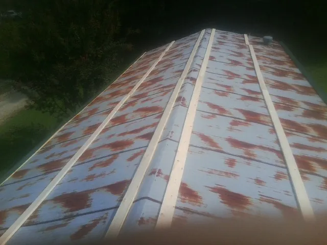 Rusted metal roof panels with new wood purlins before replacement — Storm Damage Roof Repair in Flower Mound by Roofing Brothers